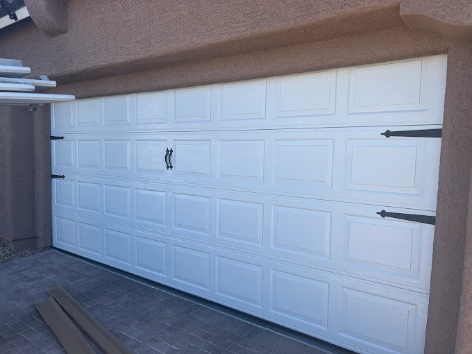 White carriage-style garage door installed by RX Garage Doors